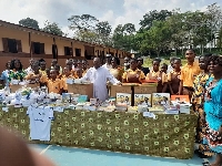 School authorities and students in a photo after receiving the items