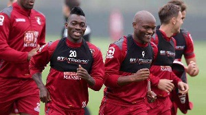 Atsu (middle) trains with Bournemouth