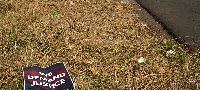 A poster is seen at a scene of a discovery of the body of a 38-year-old woman last week