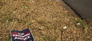 A poster is seen at a scene of a discovery of the body of a 38-year-old woman last week