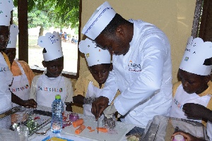 School children learning from a chef