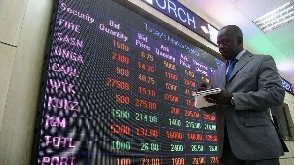Nairobi Securities Exchange employee checks the stock trading on board at the NSE head offices