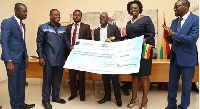 Officials of GCNet presenting the cheque to members of the Ghana @60 Planning Commitee