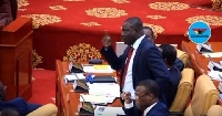 Isaac Adongo addressing members of parliament after the mid-year budget review presentation