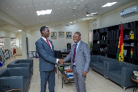 Dr Eric Nkansah shaking hands with the Minister for Education