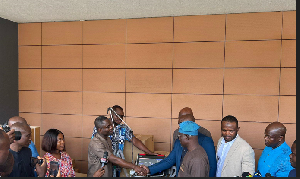 The Minister of Health presenting medical equipment to management of TTH