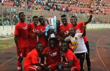 Players of Asante Kotoko jubilanting with the SWAG trophy