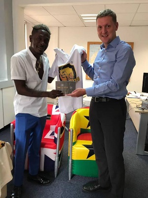 Shatta Wale presented a Shatta Movement T-Shirt, and copies of his songs to Iain Walker