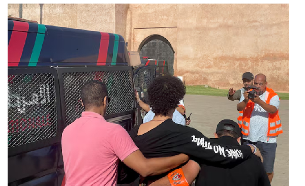 Police officers detain a young man who wanted to protest for better healthcare and education service