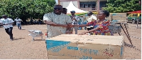 A beneficiary receiving a chest freezer from the MCE of Atebubu
