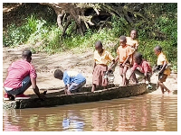 Some pupils of Achiase and nearby communities in the Western North Region board a canoe to school