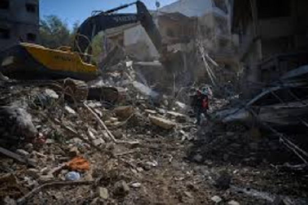 Excavator clears rubble after Israeli strike in Beirut’s Jnah district
