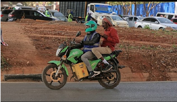 Men ride an electric motorcycle in Nairobi, Kenya