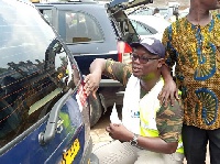 Mr Aklorbortu, W/R Chairman of the GJA, puting stickers on vehicles as part of the campaign