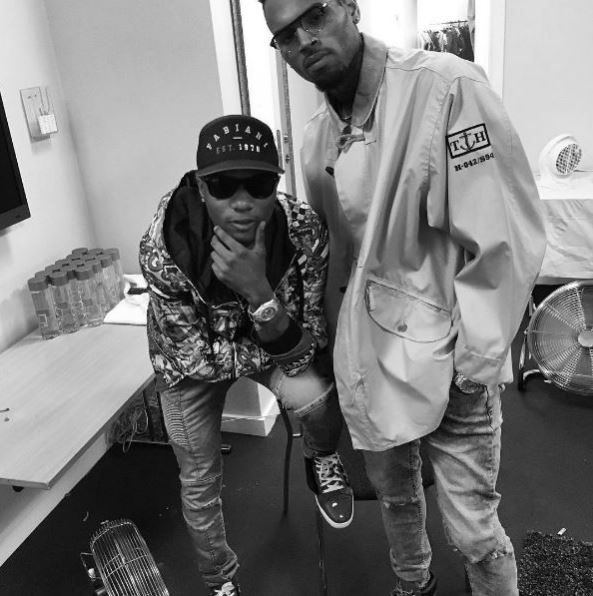 Wizkid and Chris Brown pose for a photo after performance.
