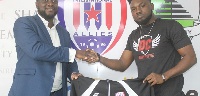 Donzy(R) with an official of Inter Allies FC