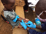 A healthcare professional injecting  a child