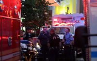 New York police and firefighters gather after the stabbing incident at Penn Station in New York