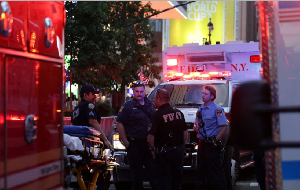 New York police and firefighters gather after the stabbing incident at Penn Station in New York