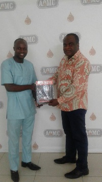 Mr. Henry Teinor presenting EG magazine to Mr. Agyemang Duah, CEO of AOMCs