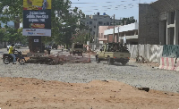 Soldiers ride in a military vehicle along a street amid an attempted coup in Cotonou, Benin