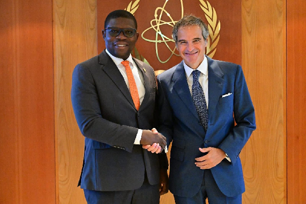 Richard Gyan Mensah (L) in a handshake with a US official