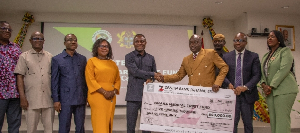 Alhaji Seidu Agongo (R) seen presenting a cheque of GH¢500,000 to the Minister of Health