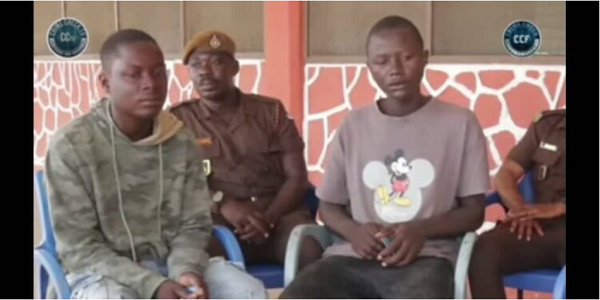 The suspects Michael Etuah and Bernard Obiri with police officers