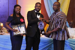 Commissioner-General Emmanuel Kofi Nti [R] presenting an award to a winner