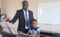 DJ Switch poses with the proprietor of Talented Royal International school