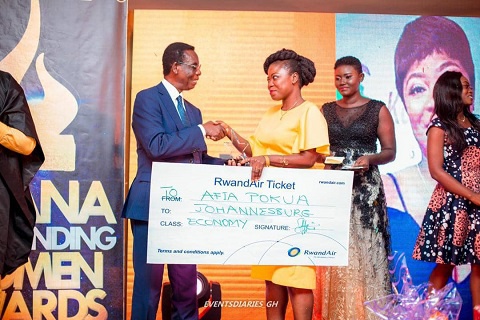 Ambassador Ray Quarcoo (L) presenting the dummy ticket to afia Pokua. With them is Afua Aduonum