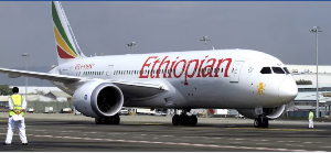 A ground crew member guides an Ethiopian Airlines  at Bole International Airport