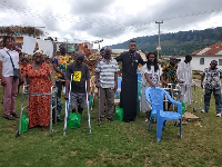 Corporal Simon Agbeko (black) in a group picture with some patients