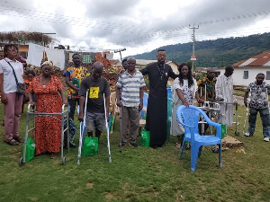 Corporal Simon Agbeko (black) in a group picture with some patients