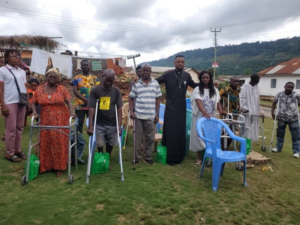 Corporal Simon Agbeko (black) in a group picture with some patients