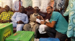 Mr.Kalmoni( right) presenting the undisclosed amount of money to the National Chief Imam