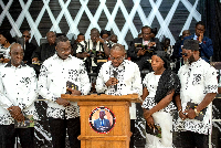 Dr Clement Apaak is seen reading the tribute with his other siblings standing by him