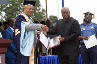 Former  President John Dramani Mahama in a hand shake with Prof. Joshua Alabi