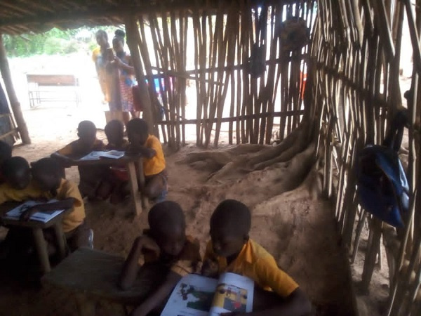 Students learning in bamboo structure