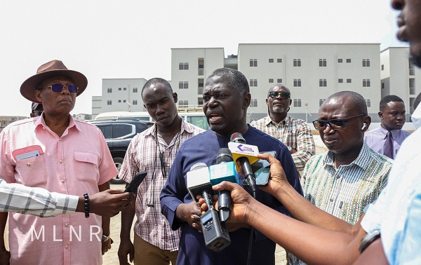 Deputy Lands Minister, Benito Owusu-Bio (M) during a visit to the construction site