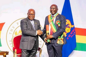 President Akufo-Addo in a handshake with Dr. Bawumia after receiving his award