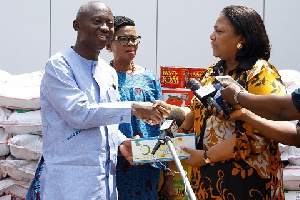 MP for Abuakwa South receiving the items from Rebecca Akufo-Addo on behalf of the institution
