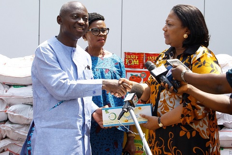 MP for Abuakwa South receiving the items from Rebecca Akufo-Addo on behalf of the institution