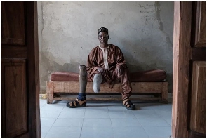 Boubacar Ba sits on a bench at the Senegalese Association of Mine Victims