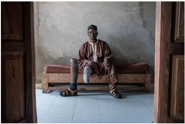 Boubacar Ba sits on a bench at the Senegalese Association of Mine Victims