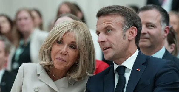 French President Emmanuel Macron  (left) and im wife Brigitte Macron
