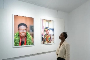 A visitor at the Ahennie exhibition of work by Emmanuel Bobbie. Photograph: Ernest Ankomah/The Guard