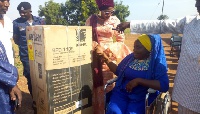 One of the beneficiaries receiving a refrigerator