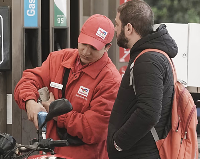 A motorbike rider looks on the price counter at a gasoline station as Egypt hiked fuel prices