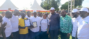Bawuah Akwasi Adjei in green outfit together with the Lands Minister and some Chiefs